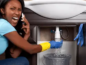 Emergency plumbing repair for a leaking sink drain under a bathroom vanity in Overland Park, KS