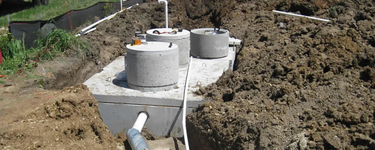 Septic system repair and installation site with tank access ports in Overland Park, KS