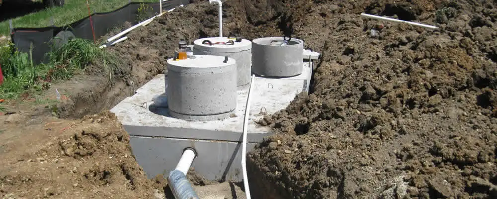 Septic system repair and installation site with tank access ports in Overland Park, KS