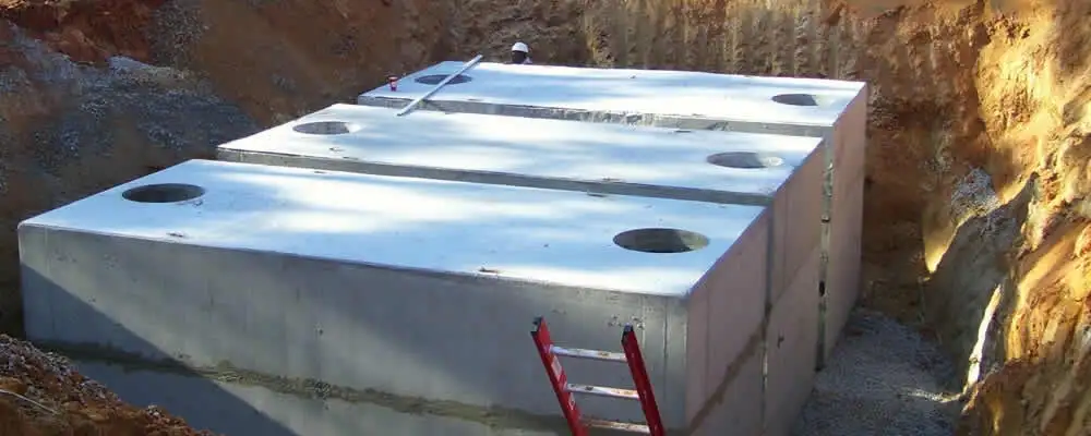 Septic tank installation site with a newly placed concrete tank in Overland Park, KS